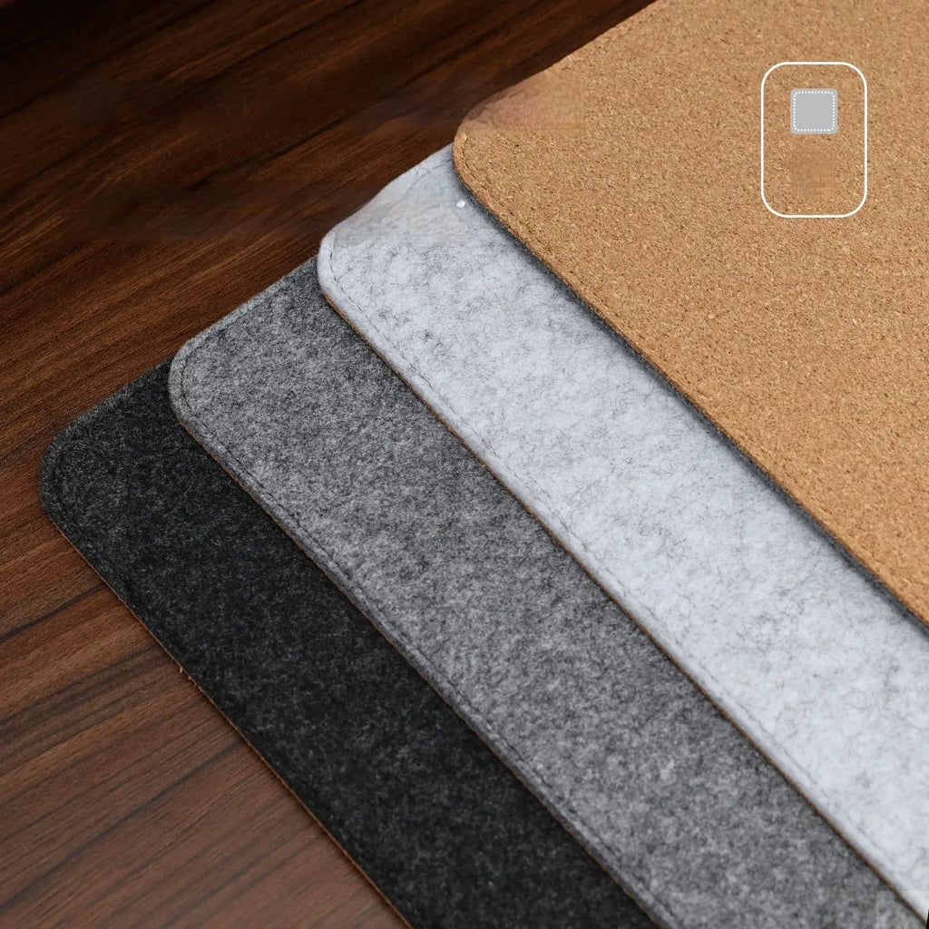 Oversized winter warm desk mat with felt and cork construction on wooden desk