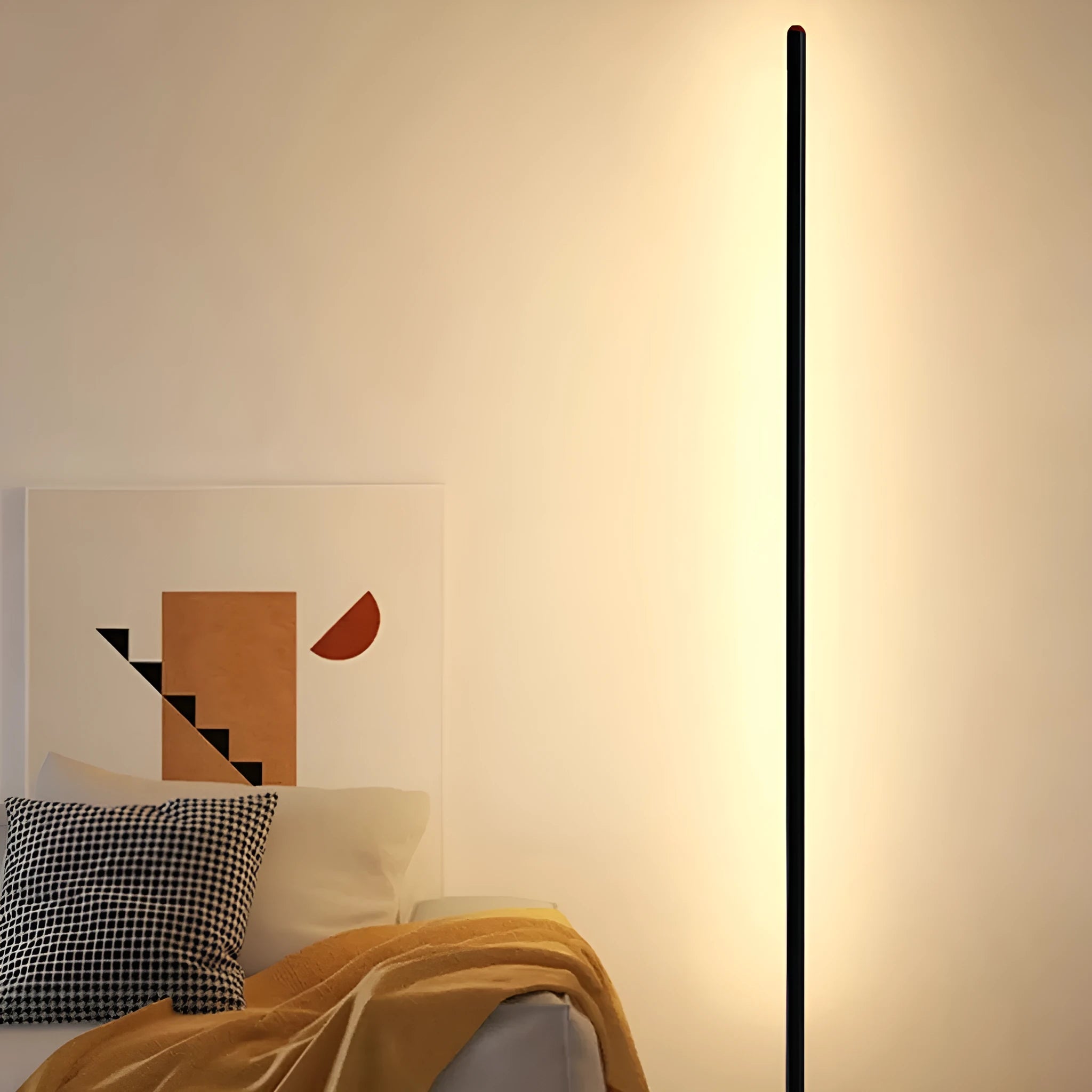Modern vertical aluminium alloy floor lamp in silver, shown beside a sofa in a living room setting.