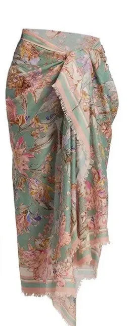 Women's beige floral bikini set with matching skirt on neutral background