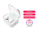 X7LED black and white sports Bluetooth in-ear headphones with USB charging case on a table