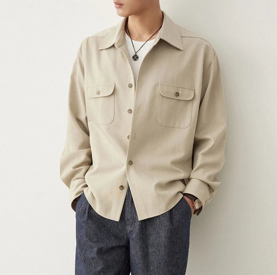 Men's light sand rice cotton lapel long sleeve shirt on a hanger.