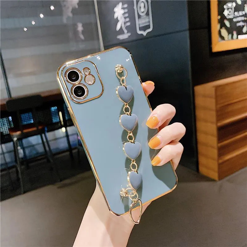Samsung mobile phone in a solid colour silicone case with an adjustable bracelet strap attached.