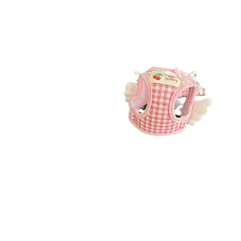 Small dog wearing pink cotton harness with chest and back leash attachment points