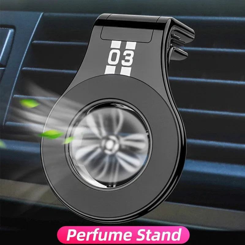Black magnetic car air vent phone holder with adjustable ball joint and fragrance disc attached.