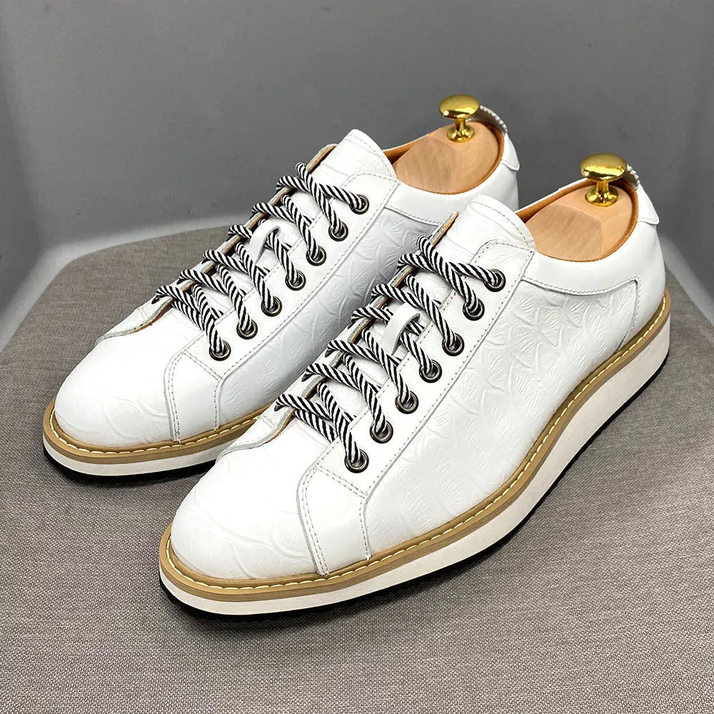 Men's low-top black embossed pattern handmade lace-up shoes on a white background.
