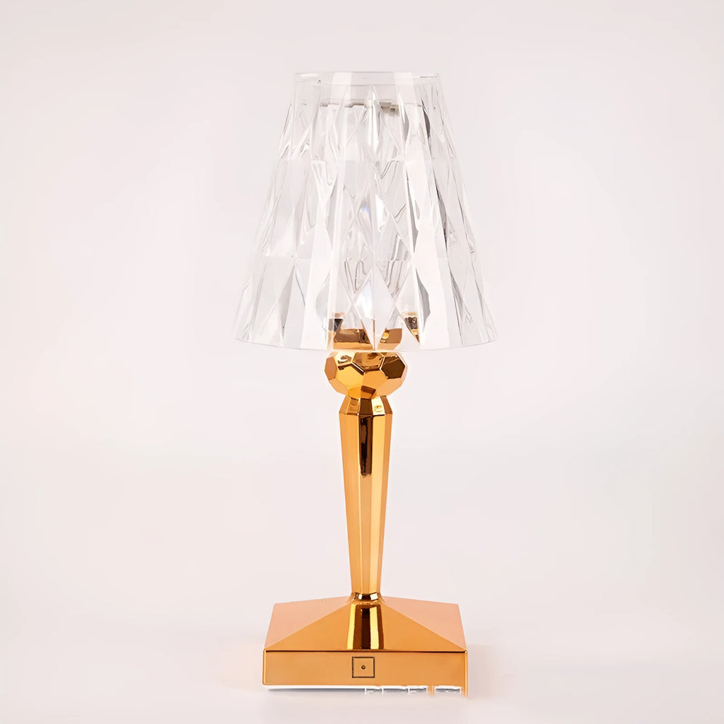 Rose gold portable touch-control projection night light on a wooden surface.