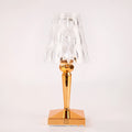 Rose gold portable touch-control projection night light on a wooden surface.