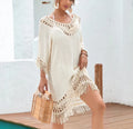 Women's apricot crocheted patchwork beach dress with half sleeves on a hanger.