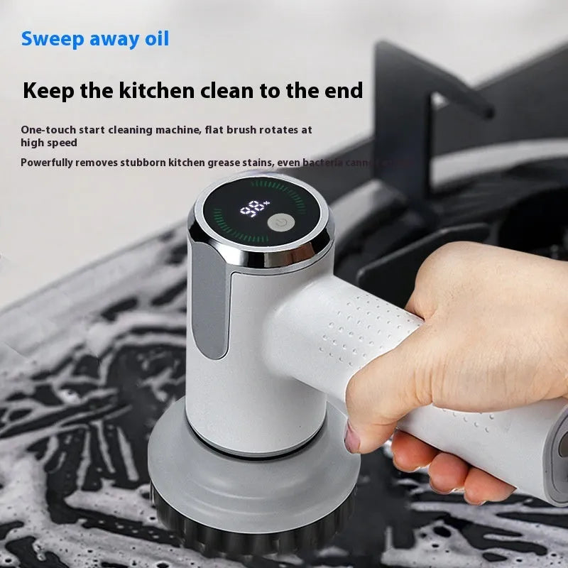 White cordless electric cleaning brush with interchangeable heads on a kitchen counter