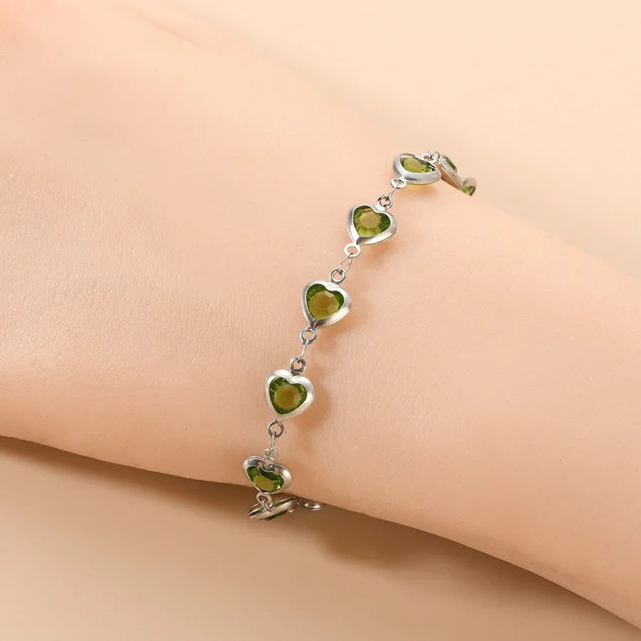 Stainless steel Devil's Eye geometric heart bracelet in red, blue, or green on a white background.