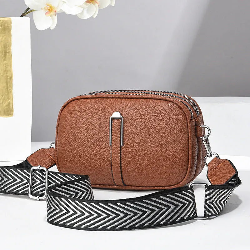 Soft PU leather women's oval crossbody bag showing slit pocket and internal organiser compartments