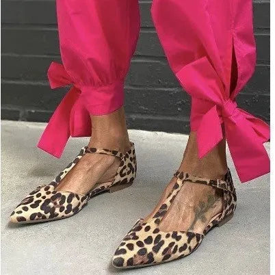 Leopard print women's court shoes with a pointed toe, cross strap, and a low chunky heel.