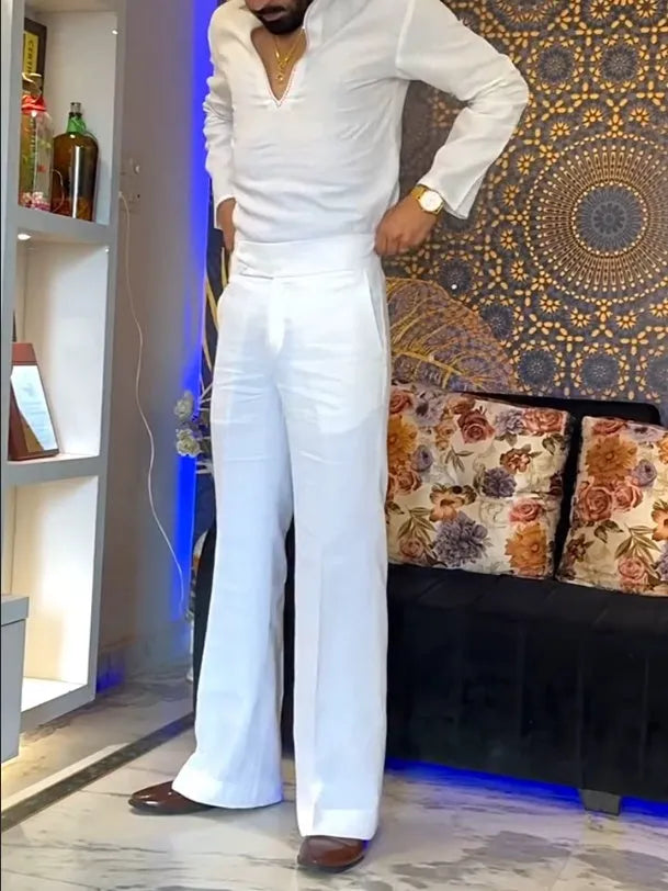 White three-piece outfit showing V-neck shirt, sleeveless vest, and full-length trousers laid flat