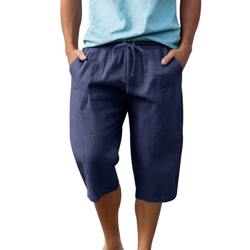 Men's loose fit linen shorts in a solid colour with a high waist and drawstring closure.