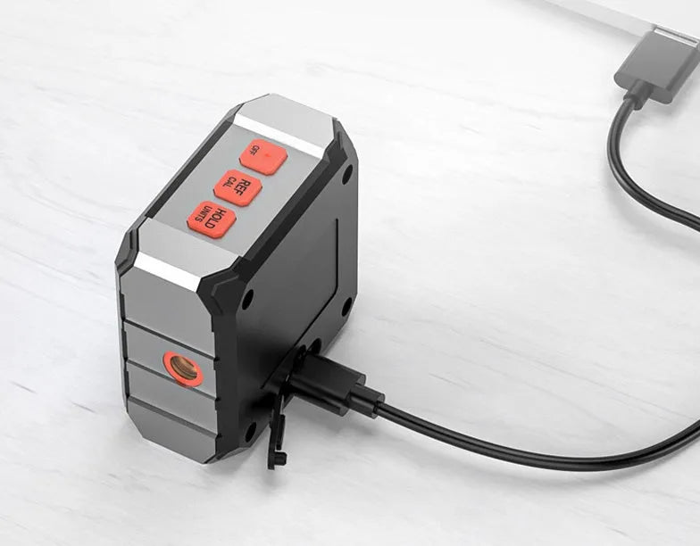 Digital laser inclinometer tool with alloy casing and backlit display on a metal surface.