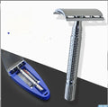 Chrome double edged safety razor with butterfly opening mechanism on a storage box
