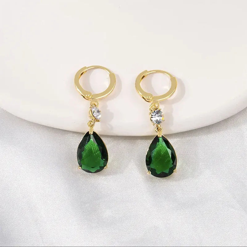 A pair of geometric green teardrop-shaped alloy drop earrings on a white background.