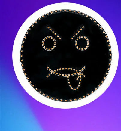 Black car rear window LED expression light showing orange smiley face design with remote control