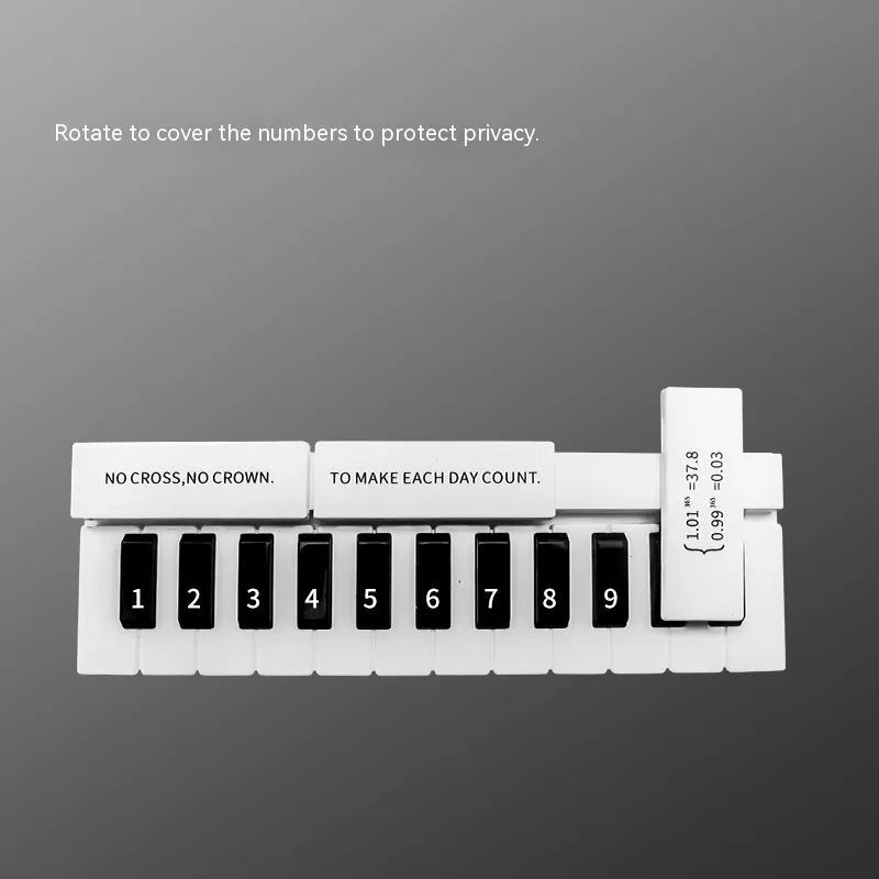 Black and white plastic piano-shaped temporary parking sign for car dashboard.