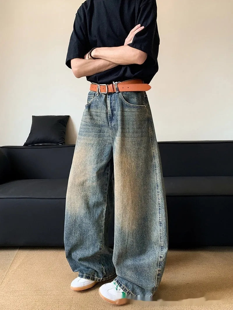 Retro blue men's distressed wide-leg jeans on a neutral background, showing machete detailing and mid-waist zip fly.