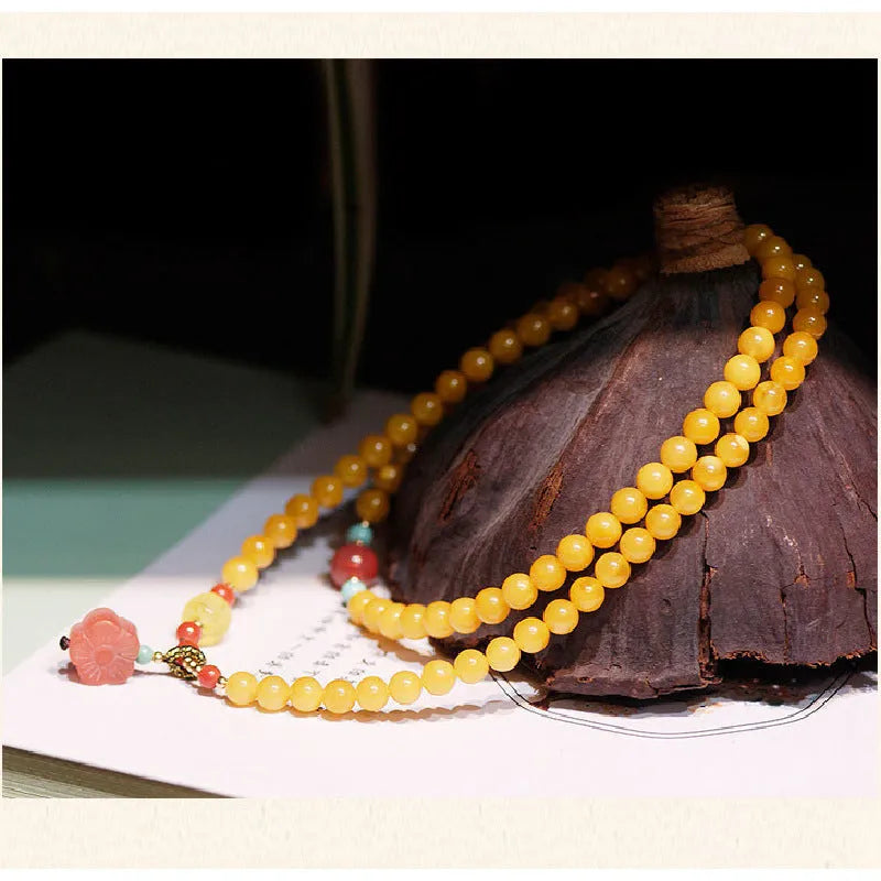 Yellow amber bracelet with 5mm round shape and animal zodiac design in retro style.