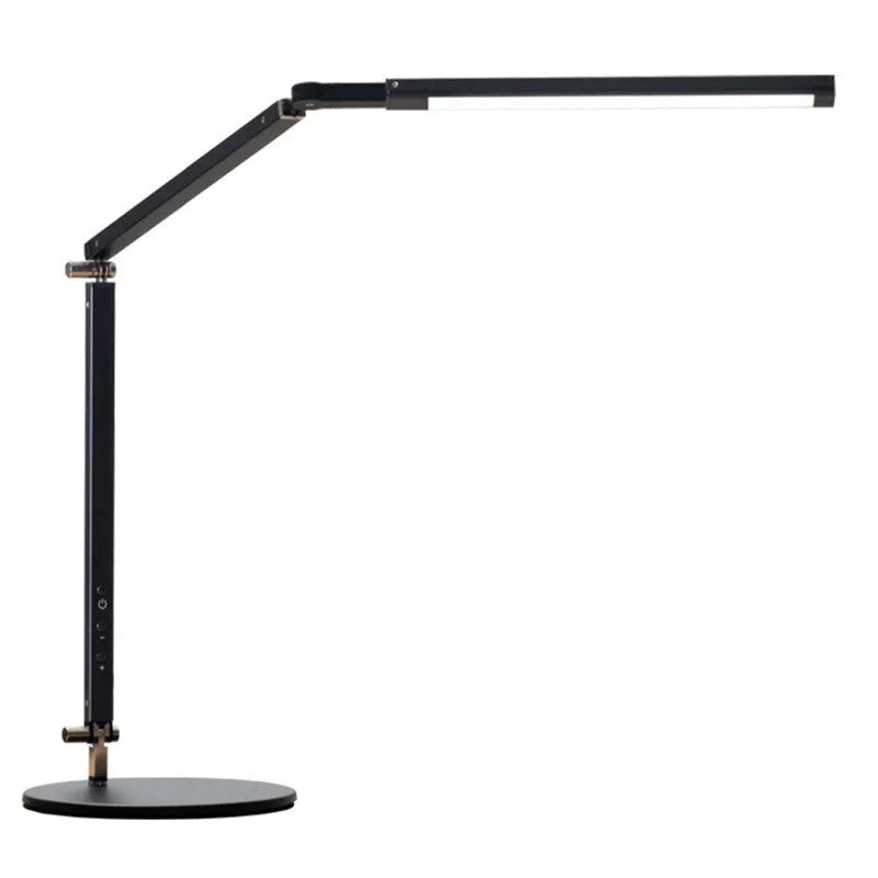 Aluminium clip-on desk lamp with adjustable arm and remote control on a wooden desk.