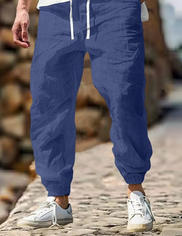 Men's straight leg summer trousers in cotton fabric with elastic waistband, shown in army green colour