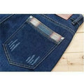 Men's dark blue slim-fit stretch skinny denim pants with zipper fly, side view