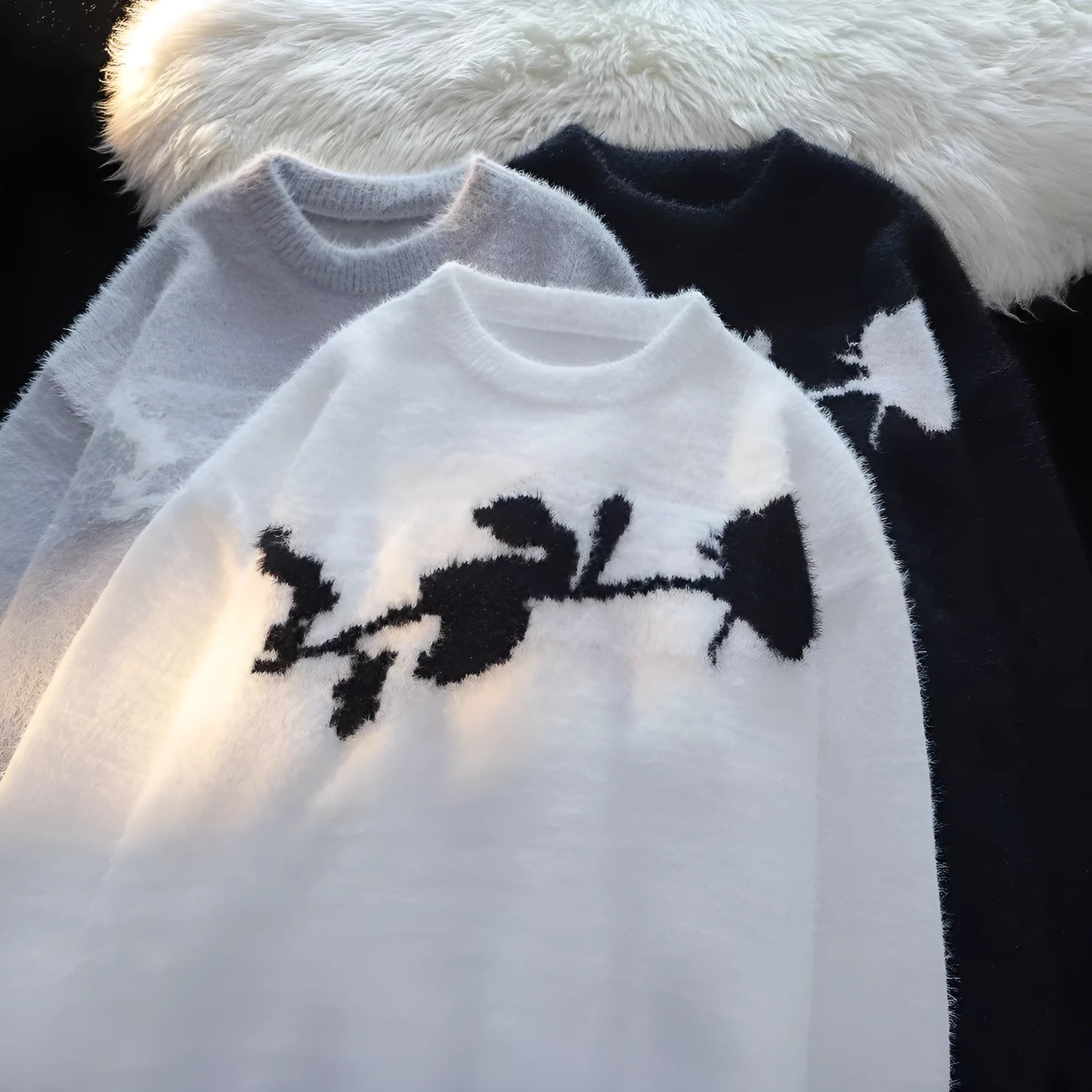 Man wearing a black cotton fleece sweater with a flocking horse and American Dark Rose pattern.