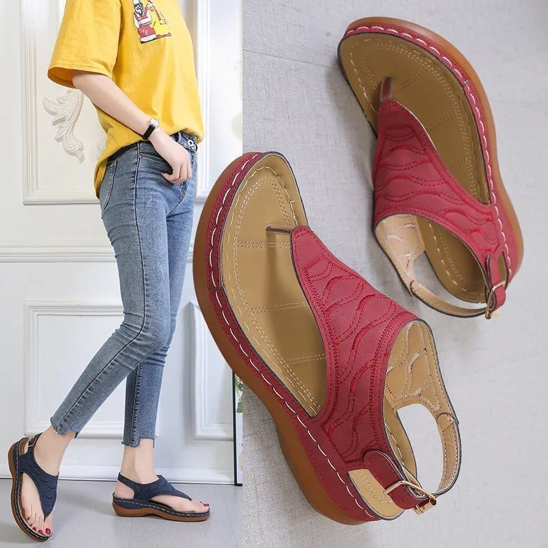 Women's casual wedge heel flip flop sandals with an adjustable buckle strap in a solid colour.