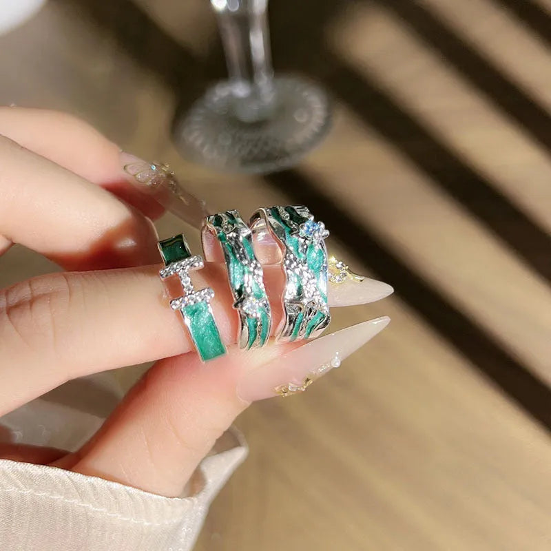 Mint green enamel asterism ring with copper folding geometric design on a hand.