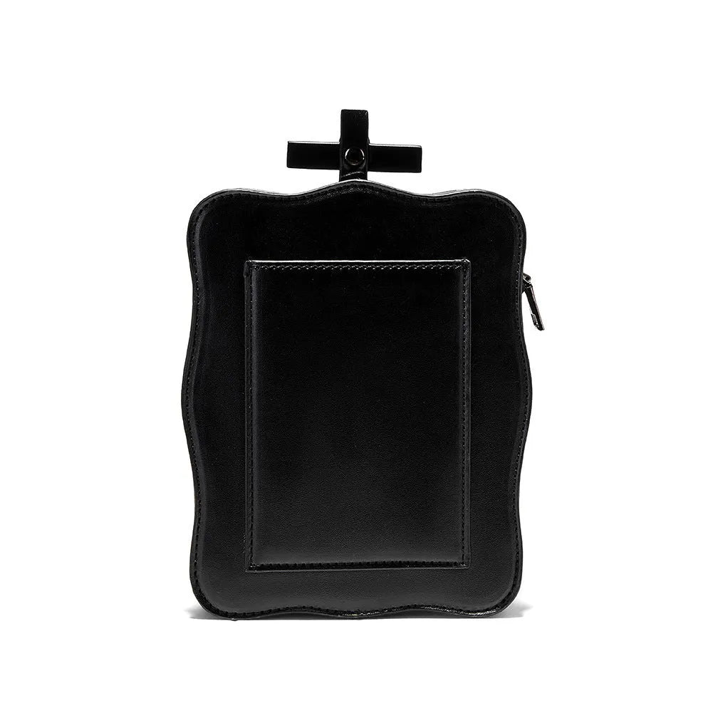 Black mini square messenger bag with a gothic embossed skull design, chain detail, and a crossbody strap.