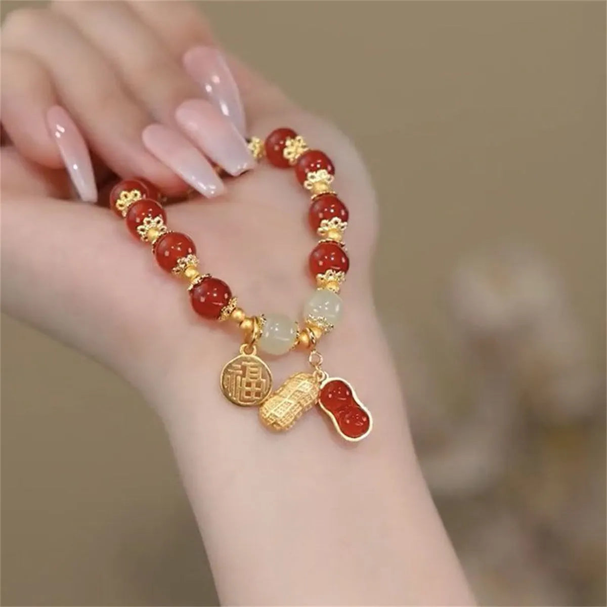 Handcrafted glass peace buckle bracelet with coloured glaze rabbit design on a white background.
