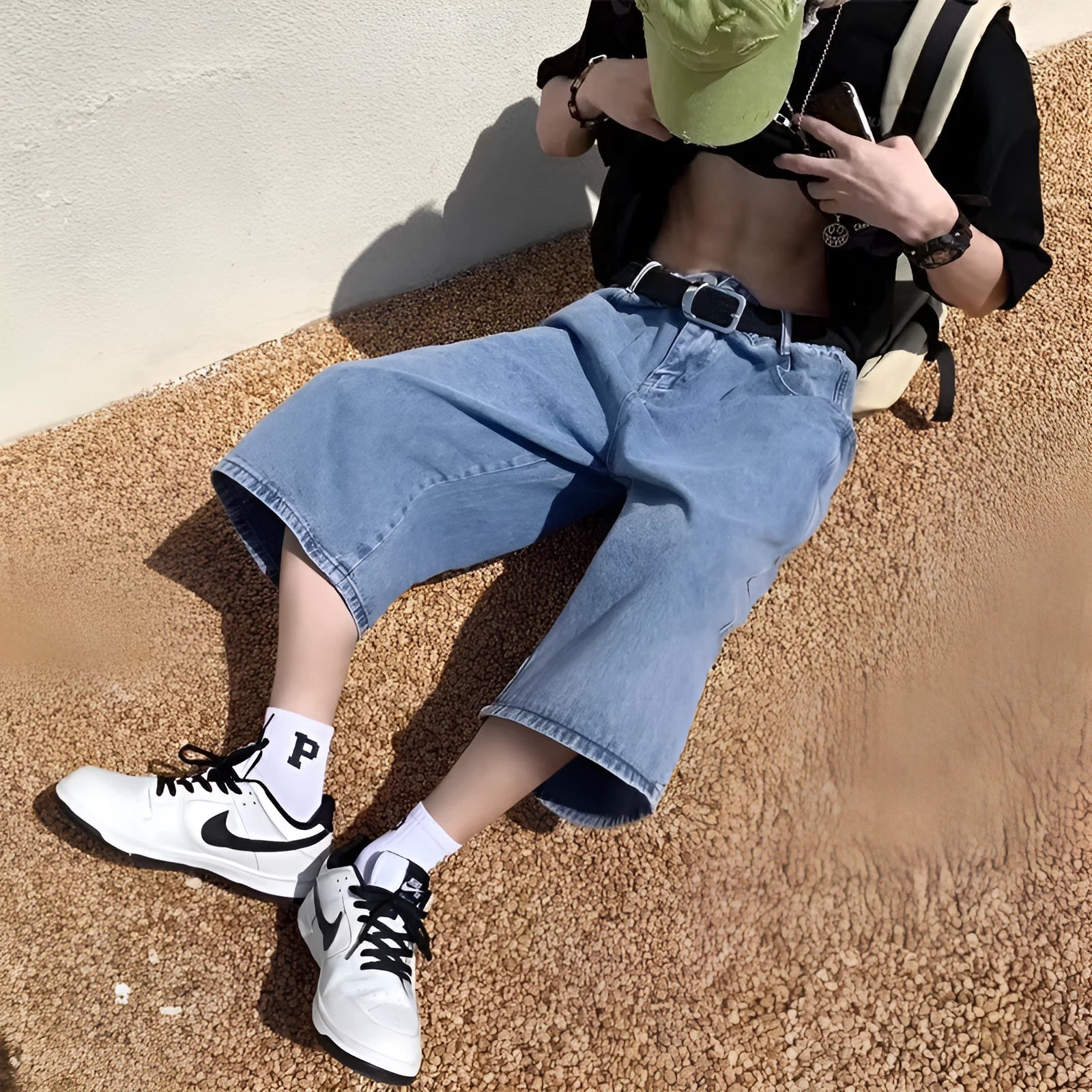 Blue men's high-waist denim pirate shorts with a cropped length and zipper fly.