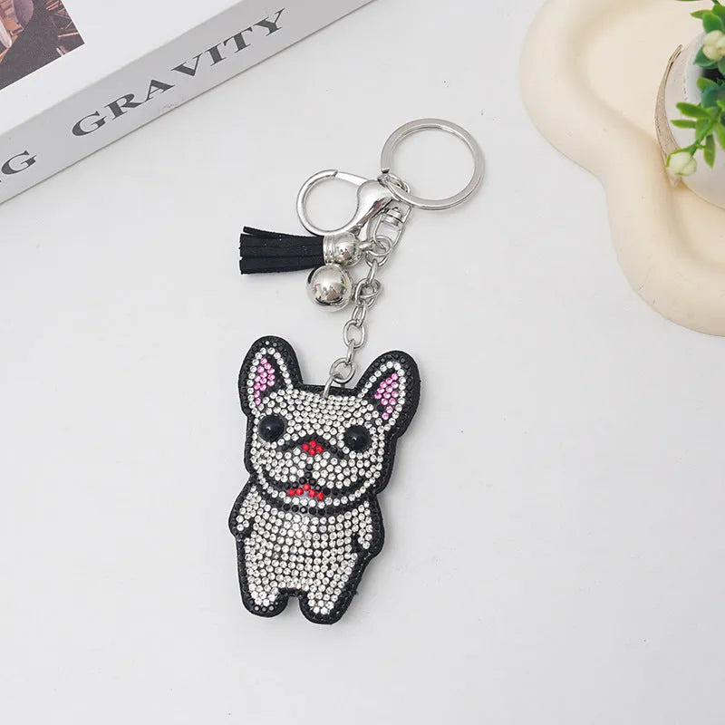 Cartoon dog alloy keychain pendant with rhinestones and bag tassel in caramel colour.