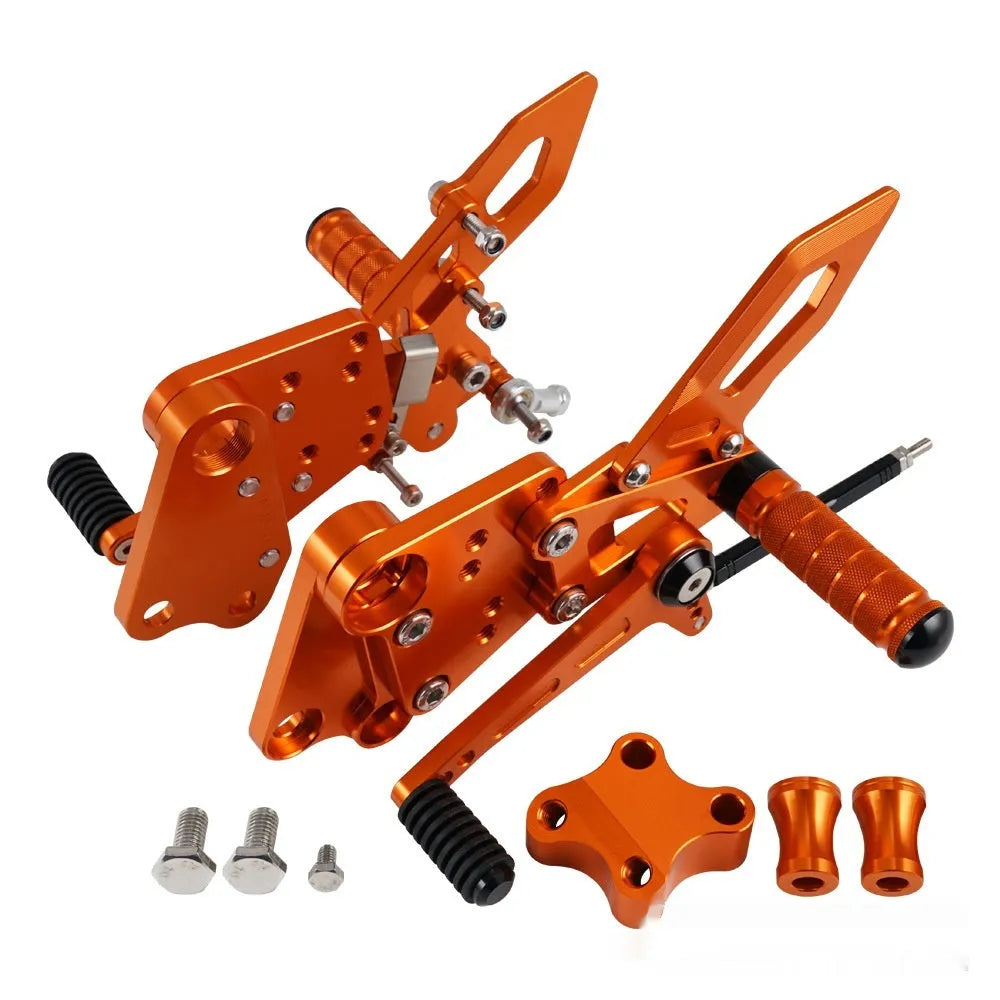 Black and orange KTM Duke motorcycle pedal support bracket assembly