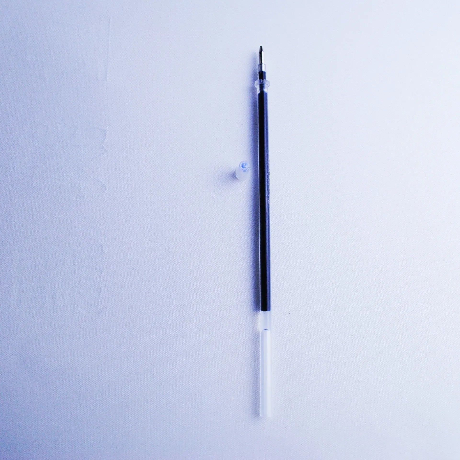 Blue automatic fading pen set with 0.5mm tip, eight refills, and pen holder on white background