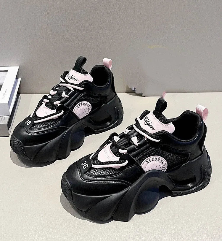Women's pink sneakers with thick soles, cross shoulder straps, and a breathable mesh lining on a white background.