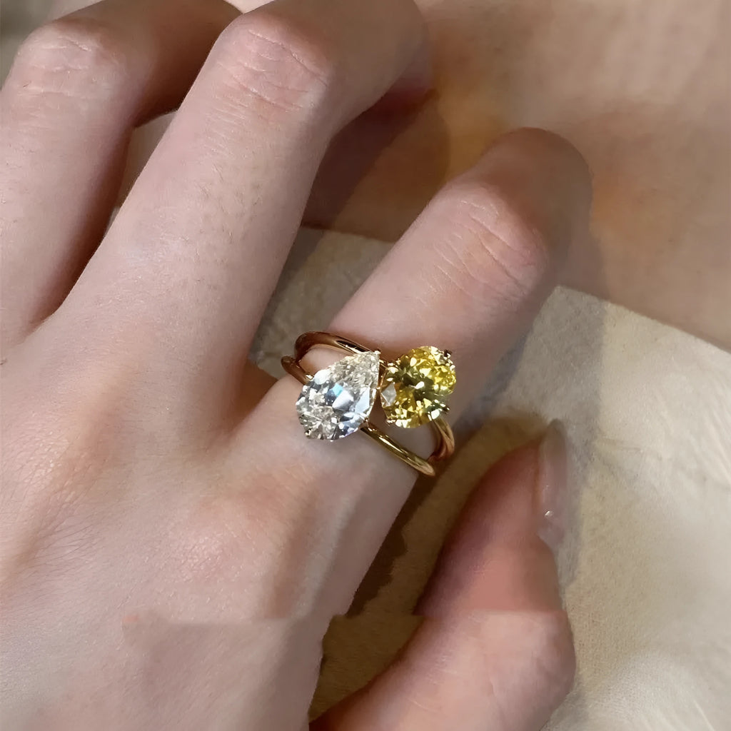 Copper geometric open ring for women with a water drop double sheng stone in a contrast colour.
