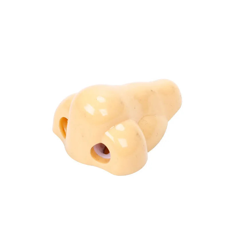 Flesh colour plastic pencil sharpener with large nostril design measuring 58x45x30mm
