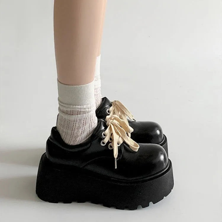 Matte black women's lace-up boots with thick rubber sole and English muffin heel