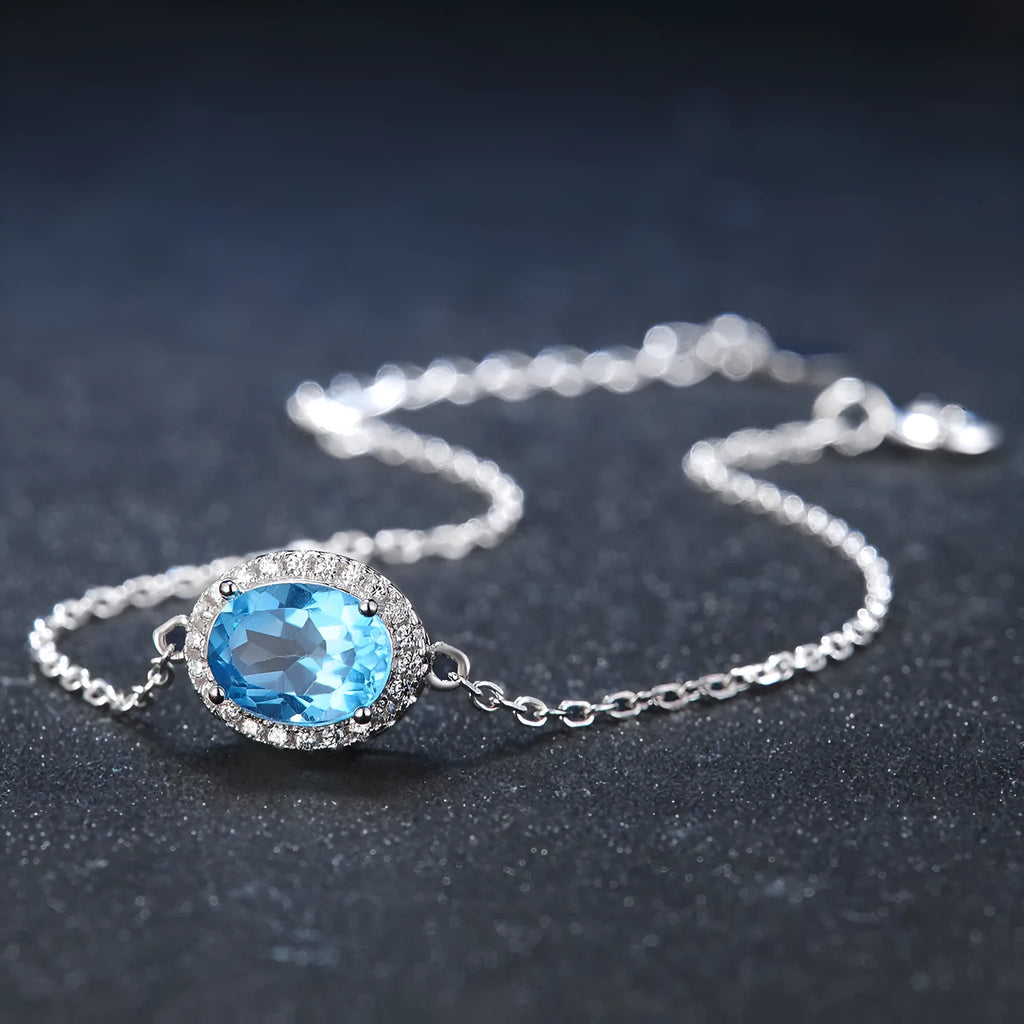 925 sterling silver blue topaz jewellery set with geometric design including earrings, necklace, ring and pendant