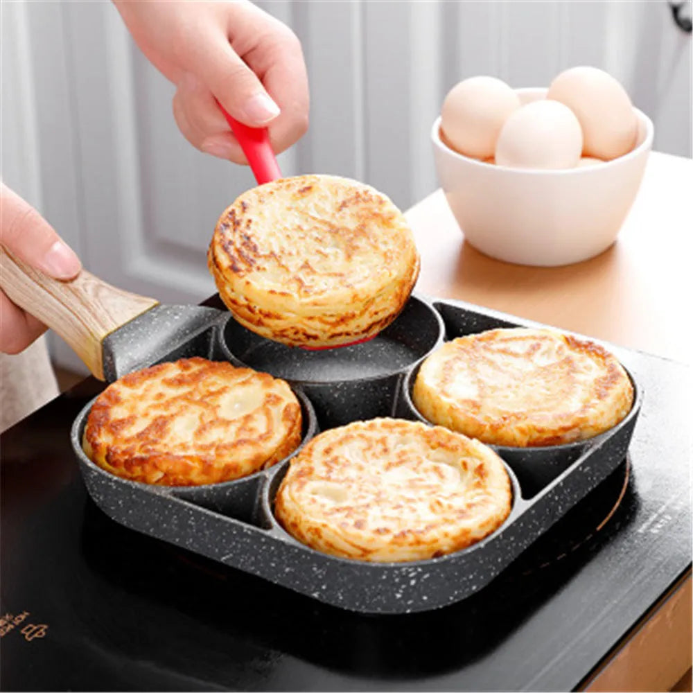 Four-hole non-stick aluminium frying pan with Bakelite handle for cooking eggs and pancakes.