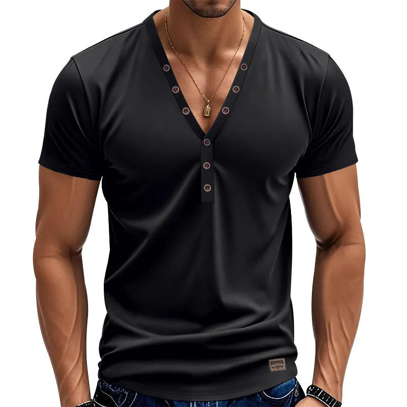 Man wearing a loose fit light blue V-neck pullover top with a button detail.