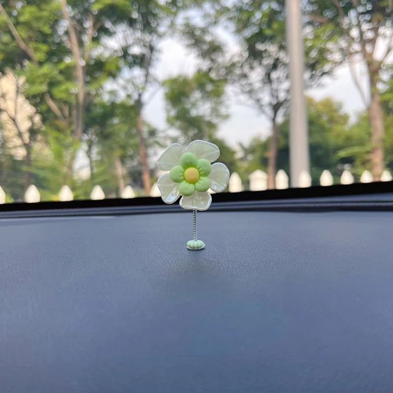 Small colourful plastic swing car decoration for hanging on rear view mirror.