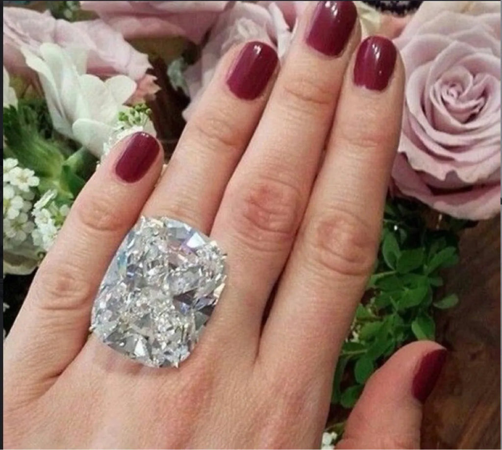 Simple white gold-coloured alloy ring with an inlaid square diamond geometric design.