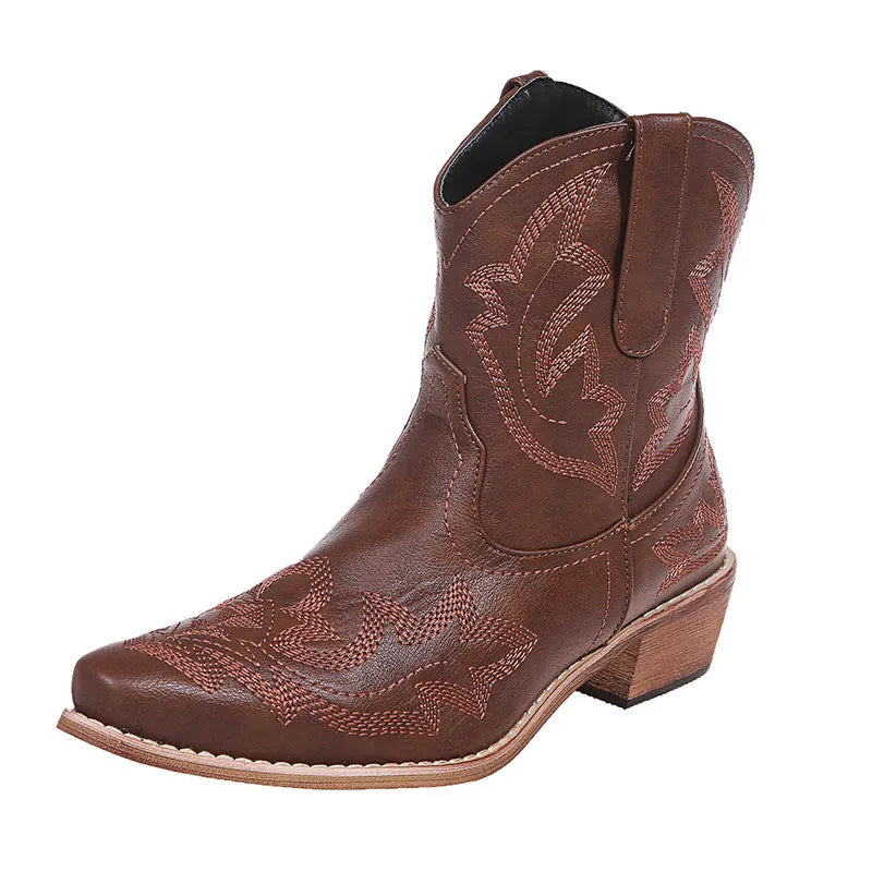 Women's blue embroidered cowboy boots with a low wedge heel and pointed toe.
