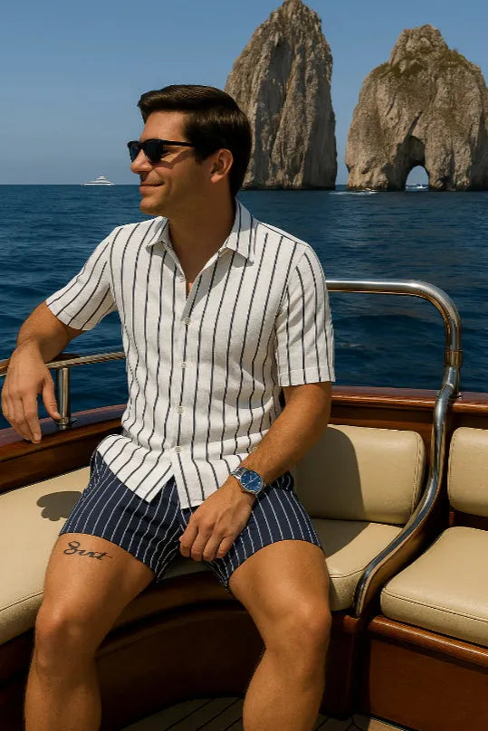 Man wearing a light mature style casual shirt and shorts beach set in a picture colour.