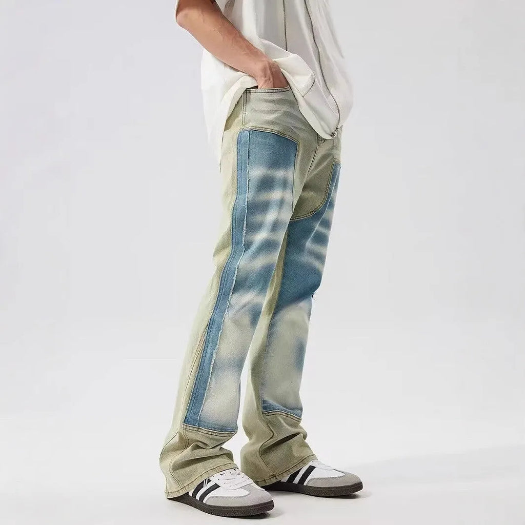 Yellow and blue retro patchwork jeans with splash-ink damaged design on denim