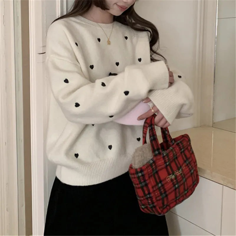 Loose beige women's pullover sweater with crew neck, long sleeves, and chest embroidery.